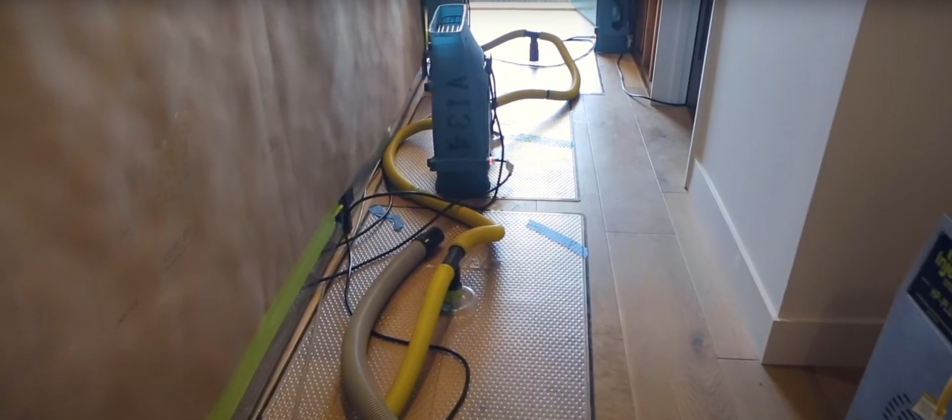 Professional water damage restoration equipment including industrial fans and dehumidifiers in action